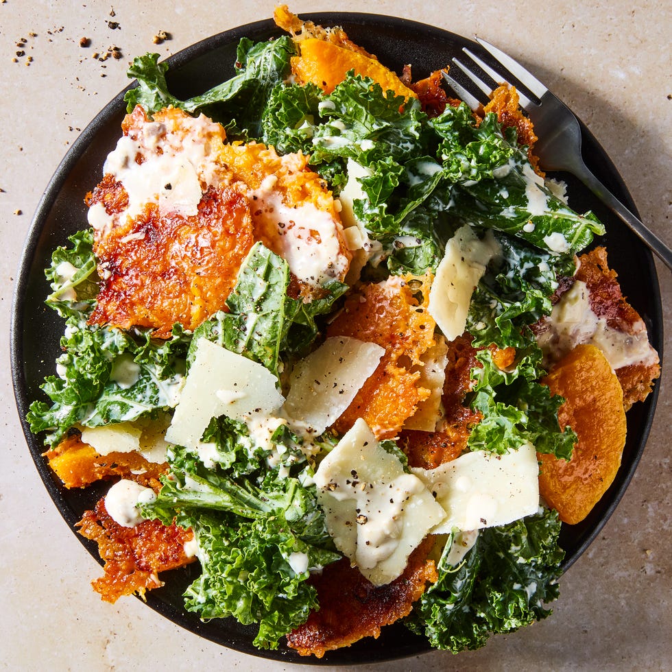 Harvest caesar salad harvest caesar salad with squash croutons and parmesan on a black plate