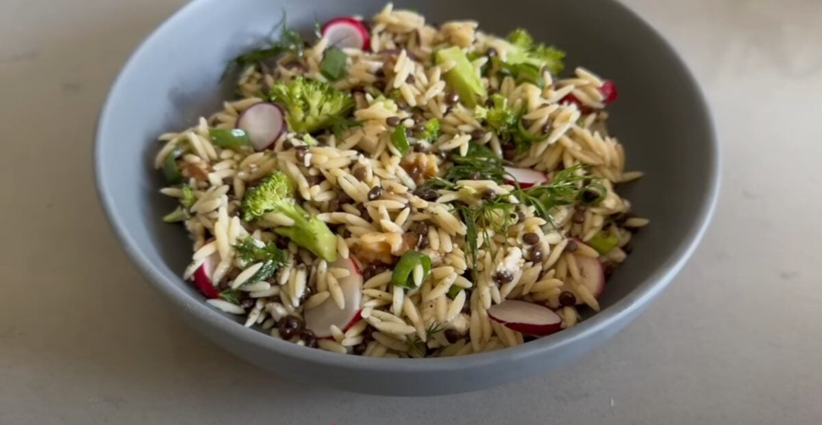 An screengrab of a vegan mother and baby "what I eat in a day" video showing plant-based orzo salad