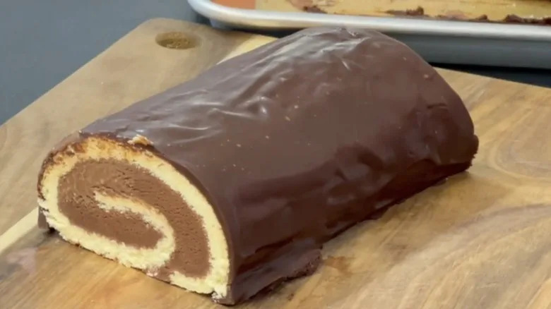 Chocolate Arctic roll on wooden serving board