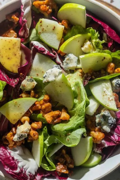 Salad with walnuts, apple slices, mixed greens, blue cheese, and vinaigrette