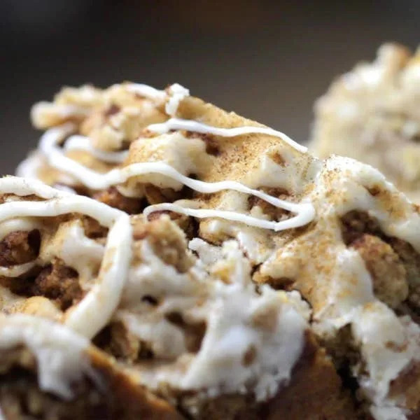 Close-up of apple crumble bread topped with a maple glaze.