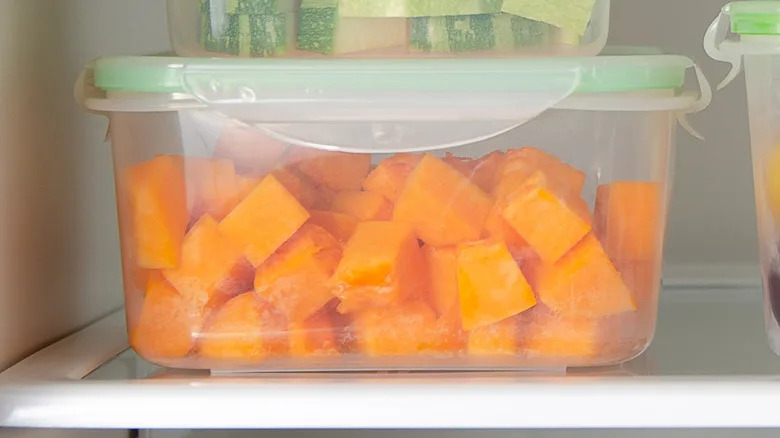 Close-iup of vegetables in plastic containers in a fridge