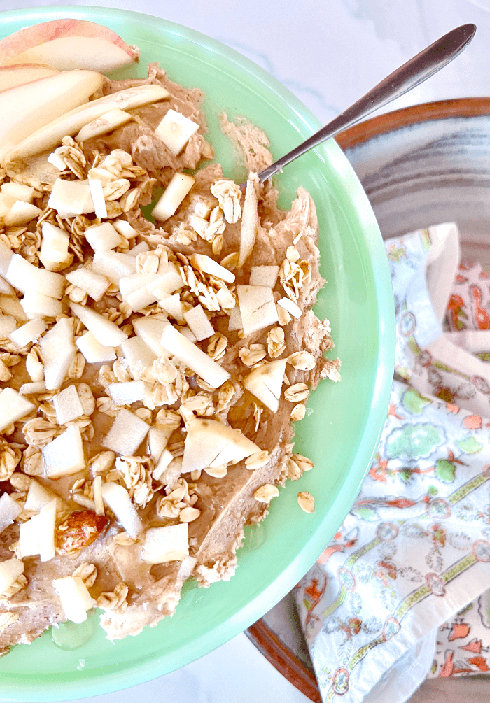 light green serving plate with butter, granola, and chopped apples
