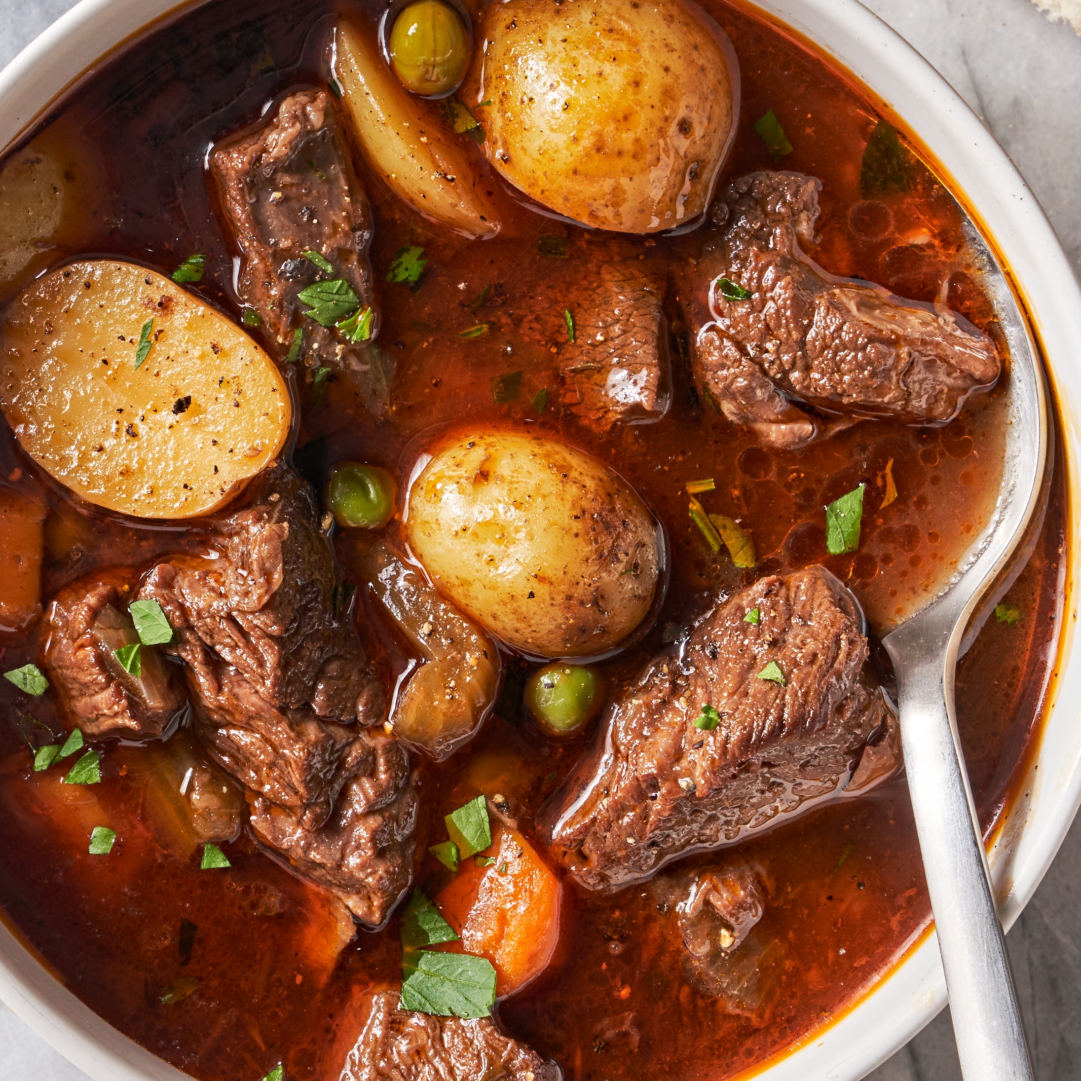 beef stew with potatoes, beef, carrots, and peas