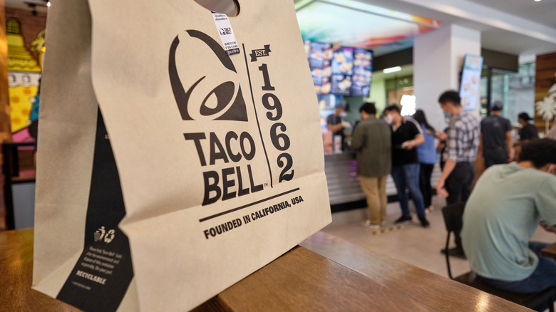 Taco Bell bag on table in restaurant